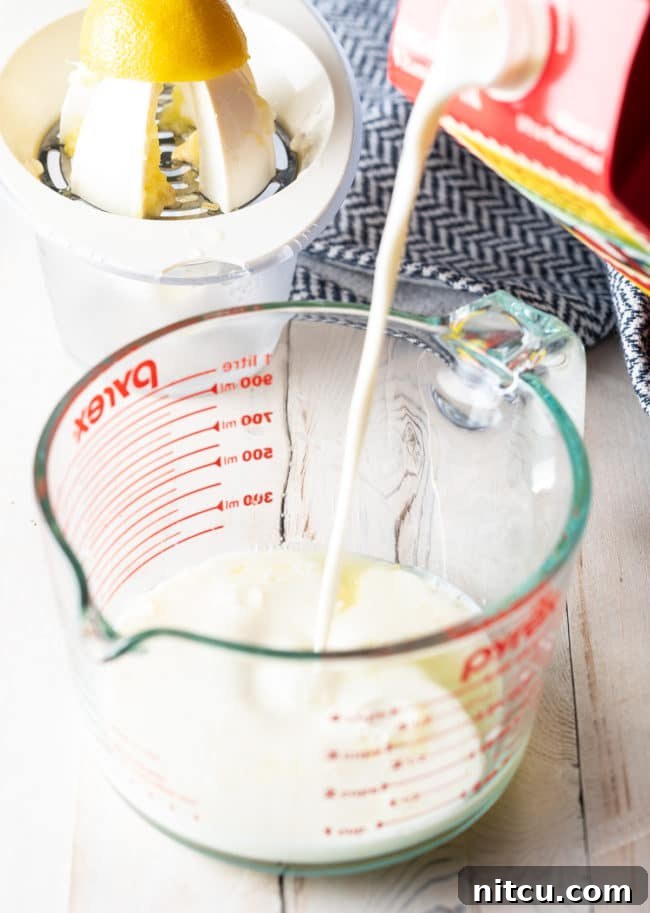 Whipping Up Buttermilk At Home 6 Pouring fresh milk into a glass measuring cup, preparing to make buttermilk.
