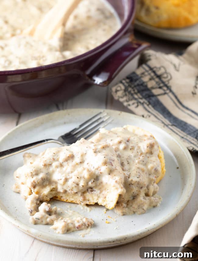 Effortless Homemade Sausage Gravy 8 Easy Sausage Gravy and Biscuits on a plate.