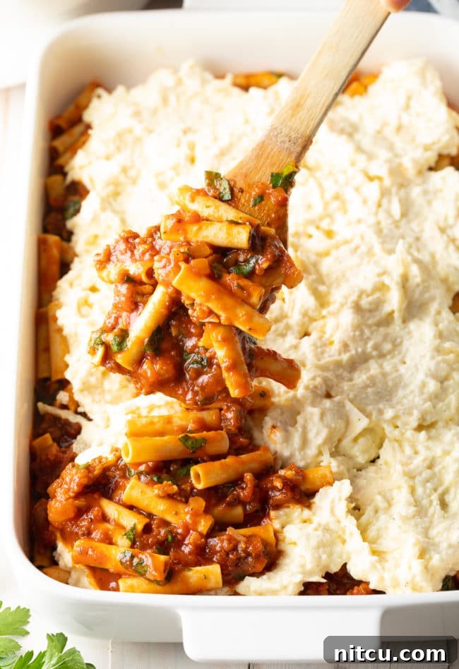Hearty Italian Sausage Ziti Bake 3 Ricotta Baked Ziti Recipe - layering in pan, showing the uncooked layers