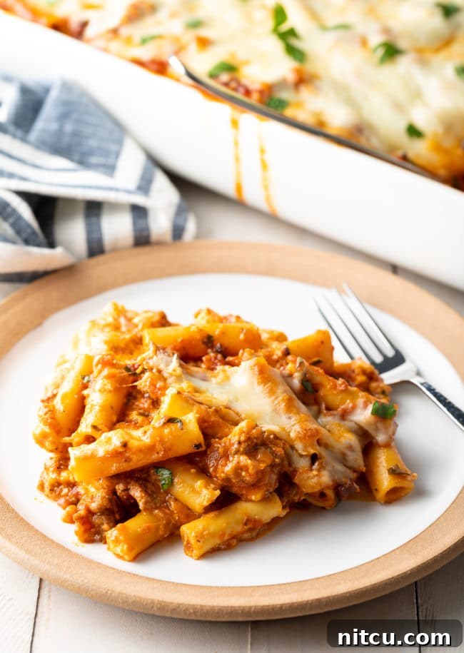 italian-sausage-baked-ziti Close-up of baked ziti with Italian sausage and ricotta on a plate, ready to eat