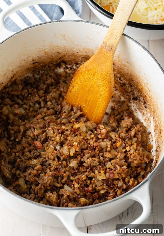 ricotta-cheese-preparation Italian sausage cooking in a pan for baked ziti recipe