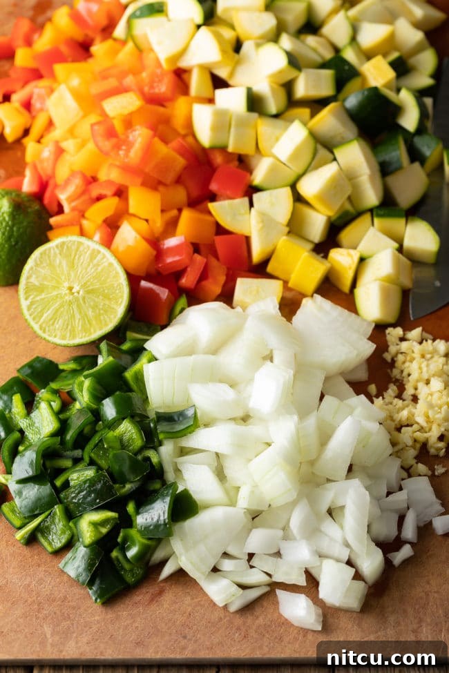 Chopped Zucchini, yellow squash, and bell peppers for Calabacitas Con Queso Recipe, ready for cooking.