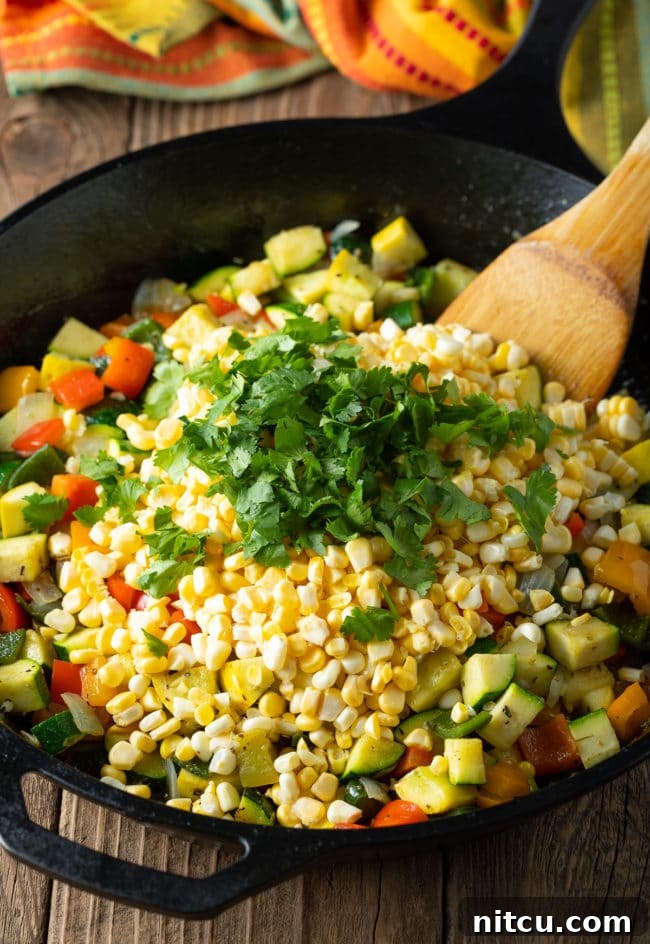 Freshly cooked Calabacitas Con Elote Recipe with vibrant vegetables and seasonings.