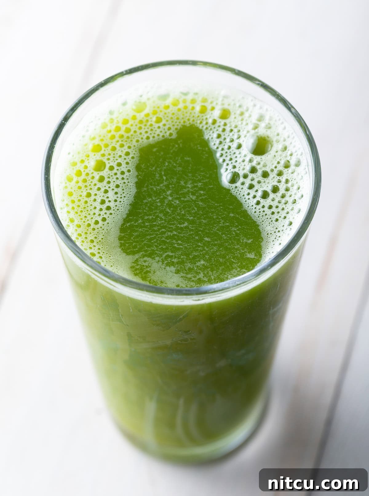 Homemade Celery Juice for Wellness 9 Top down view of celery juice in a glass.