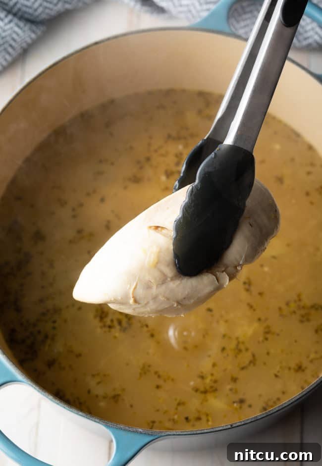 Step-by-step: Cooked chicken breasts removed from the soup pot, ready for shredding.