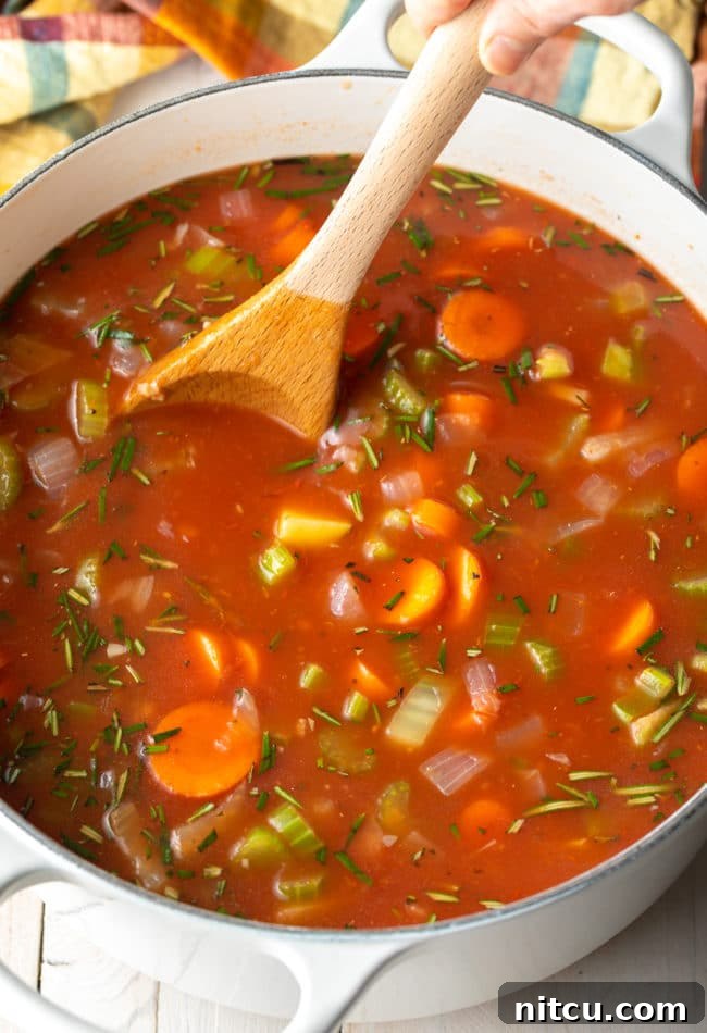 Rustic Tuscan Lentil Soup 7 Tuscan Lentil Soup simmering on the stovetop, a comforting and flavorful vegetarian dish.