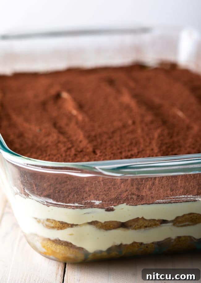 Espresso Pick-Me-Up Delight 11 The finished tiramisu, artfully layered in a baking dish, ready for chilling and its final cocoa dusting.