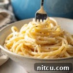 A perfectly plated Cacio e Pepe dish, ready to be enjoyed.