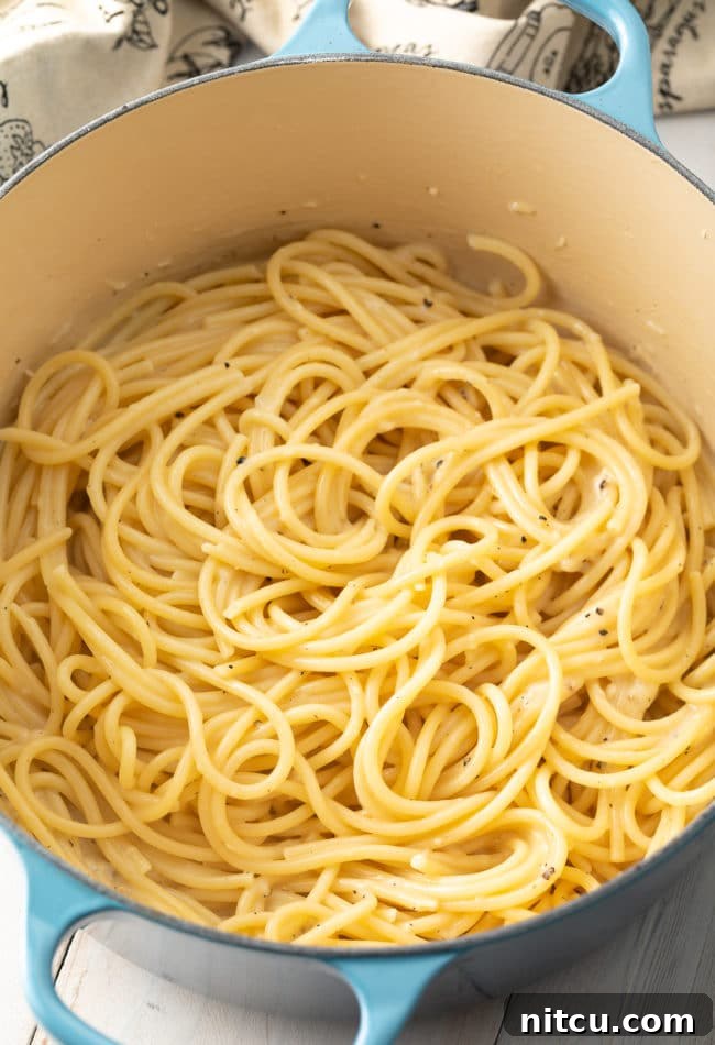 Finished Cacio e Pepe pasta, perfectly coated in sauce, in the pot.
