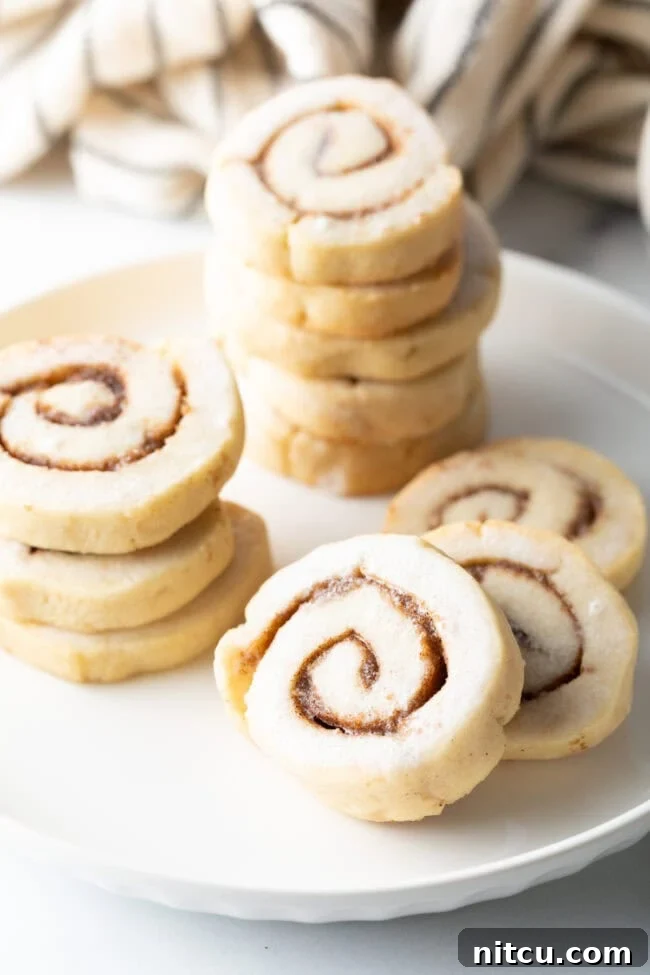 cinnamon-spice-cookies.jpg Stacks of glazed cinnamon roll cookies, showing the detailed swirl patterns