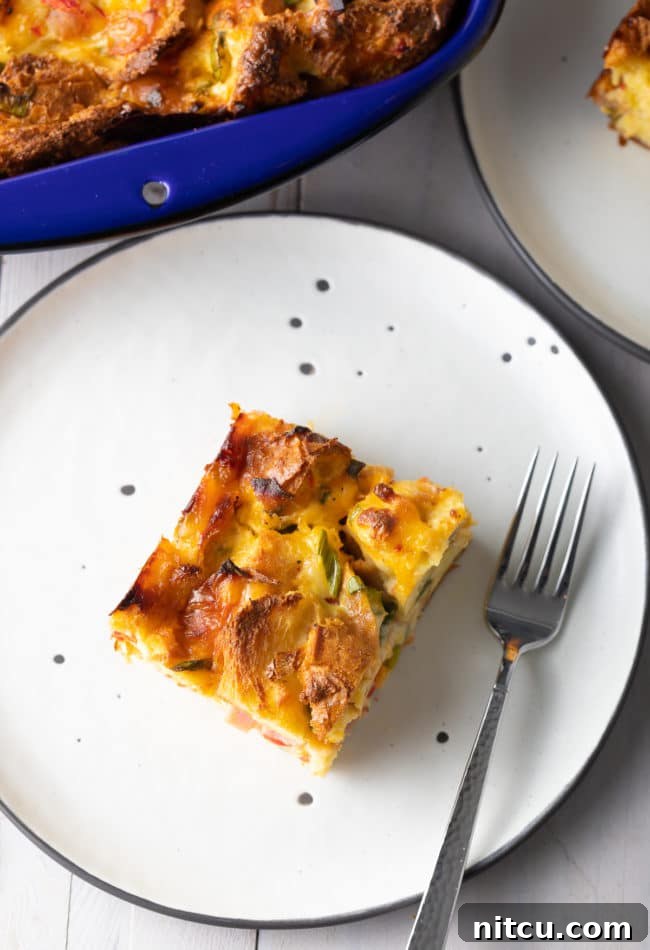make-ahead-breakfast make ahead breakfast (overnight breakfast casserole) cut into pieces and served on black and white plates