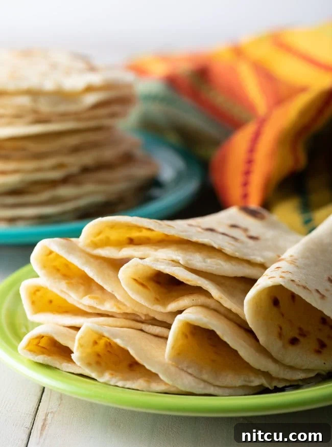 Crafting Perfect Flour Tortillas From Scratch 3 Best Flour Tortillas Recipe - soft folded tortillas on plate