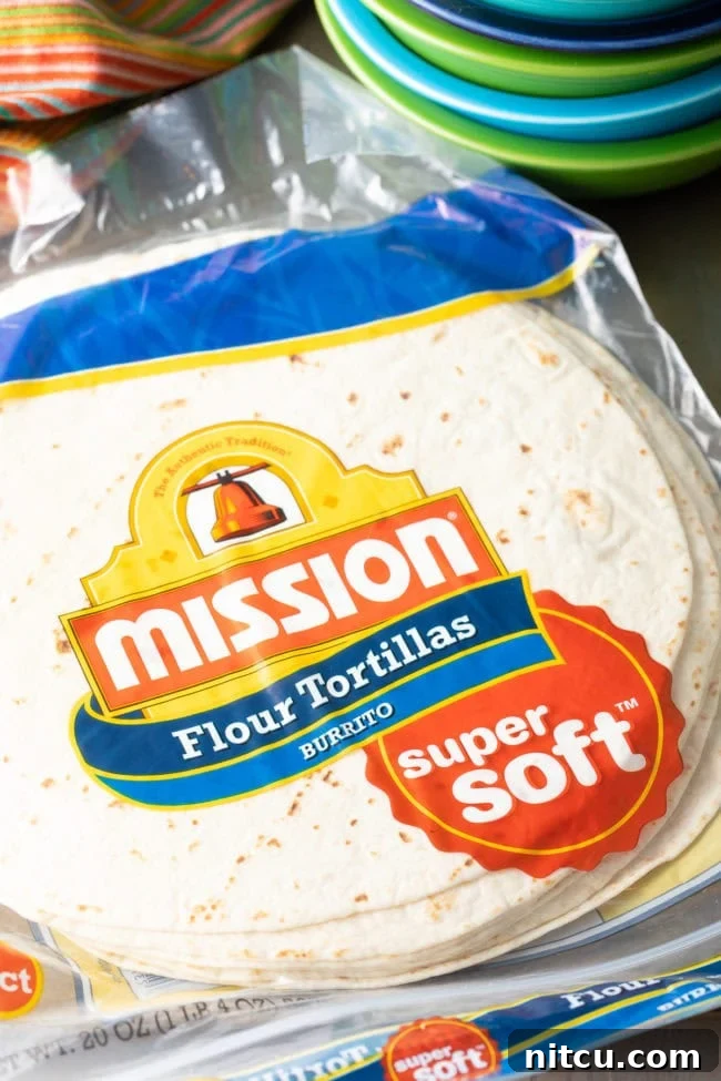 Stack of large burrito-sized flour tortillas, ready for preparation.