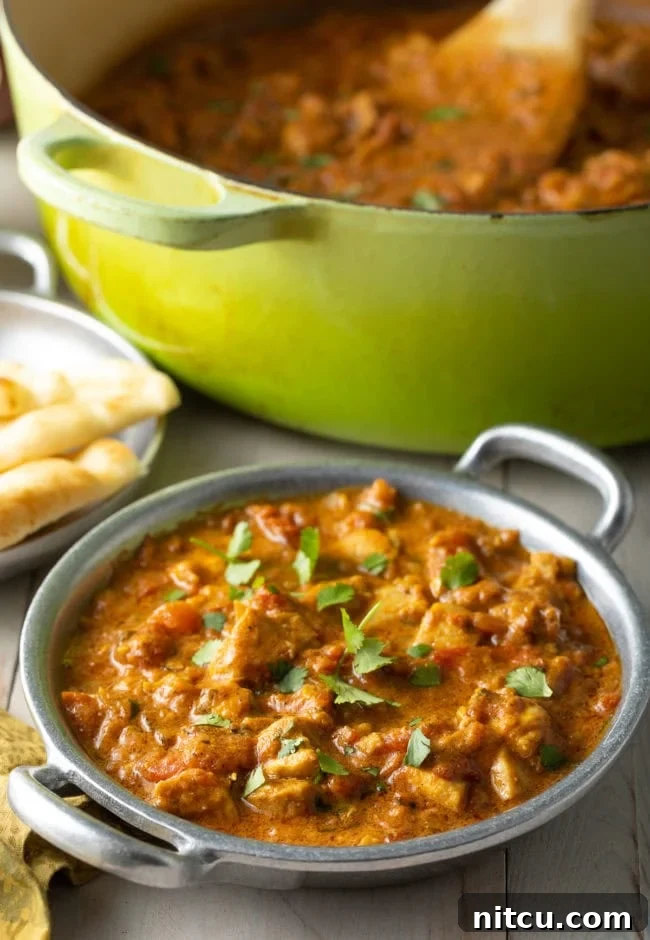 Fiery Madras Chicken 12 Easy Madras Chicken in a bowl next to a dutch oven full of curry.