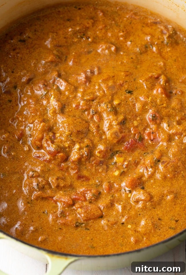 Fiery Madras Chicken 8 Stirring chicken into the rich curry sauce.