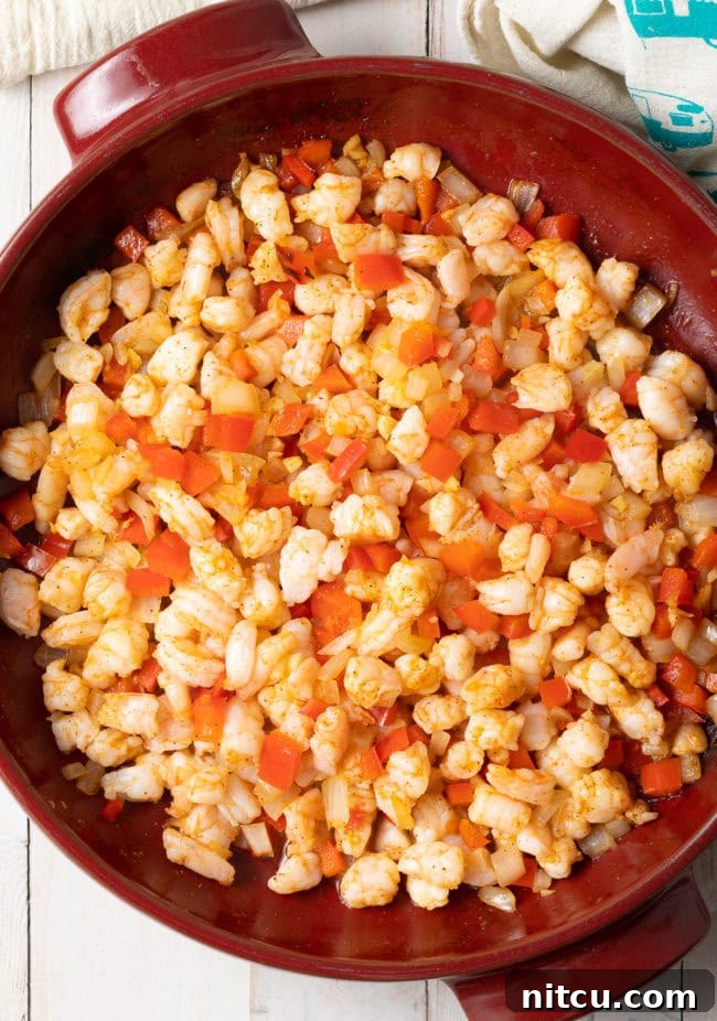 Fiery Cajun Shrimp Dip 5 Hot shrimp dip - shrimp and other ingredients mixed together in a making dish.