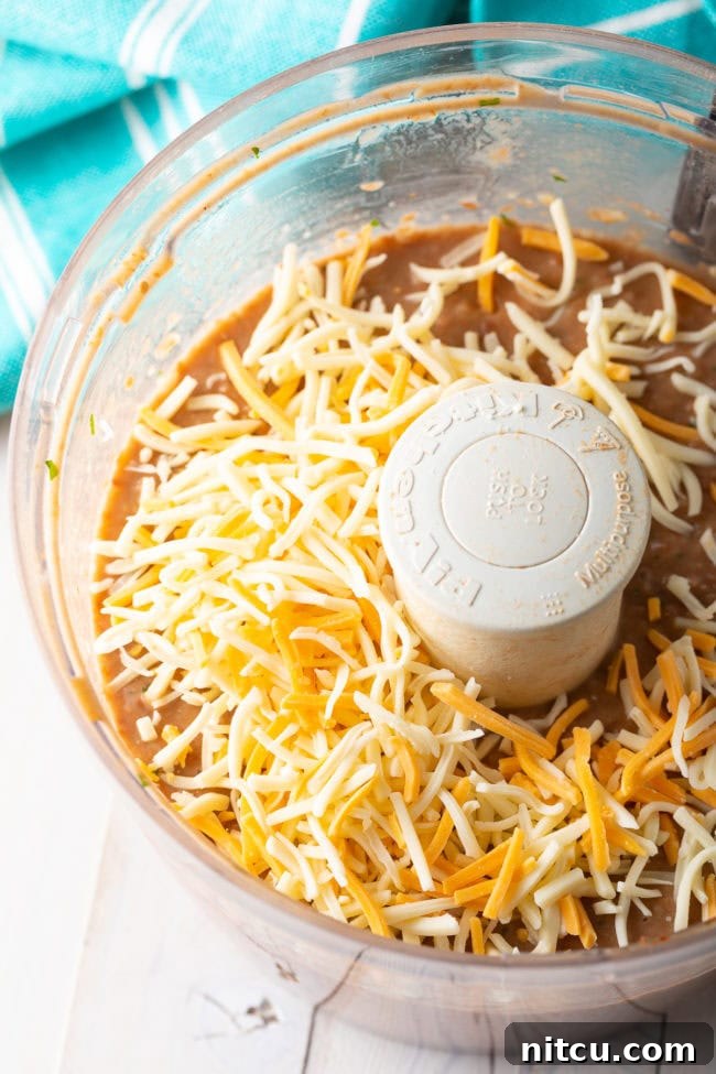 Ultimate Homemade Bean Dip 8 Creamy bean dip in a food processor, after being blended to the perfect consistency.