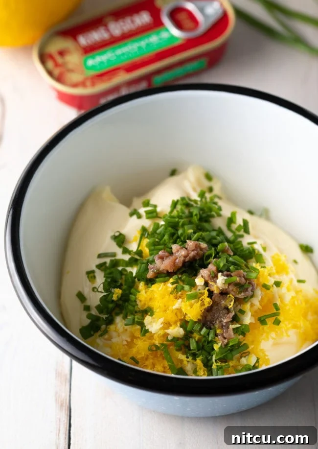 Enchanted Aioli 5 A white bowl with ingredients for aioli sauce.