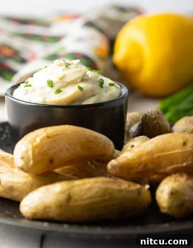 Enchanted Aioli 8 A bowl of aioli sauce on a plate with fingerlings.