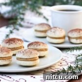 Espresso Mascarpone Cookies 2 Delicious Tiramisu Cookies stacked on a platter, dusted with cocoa powder.