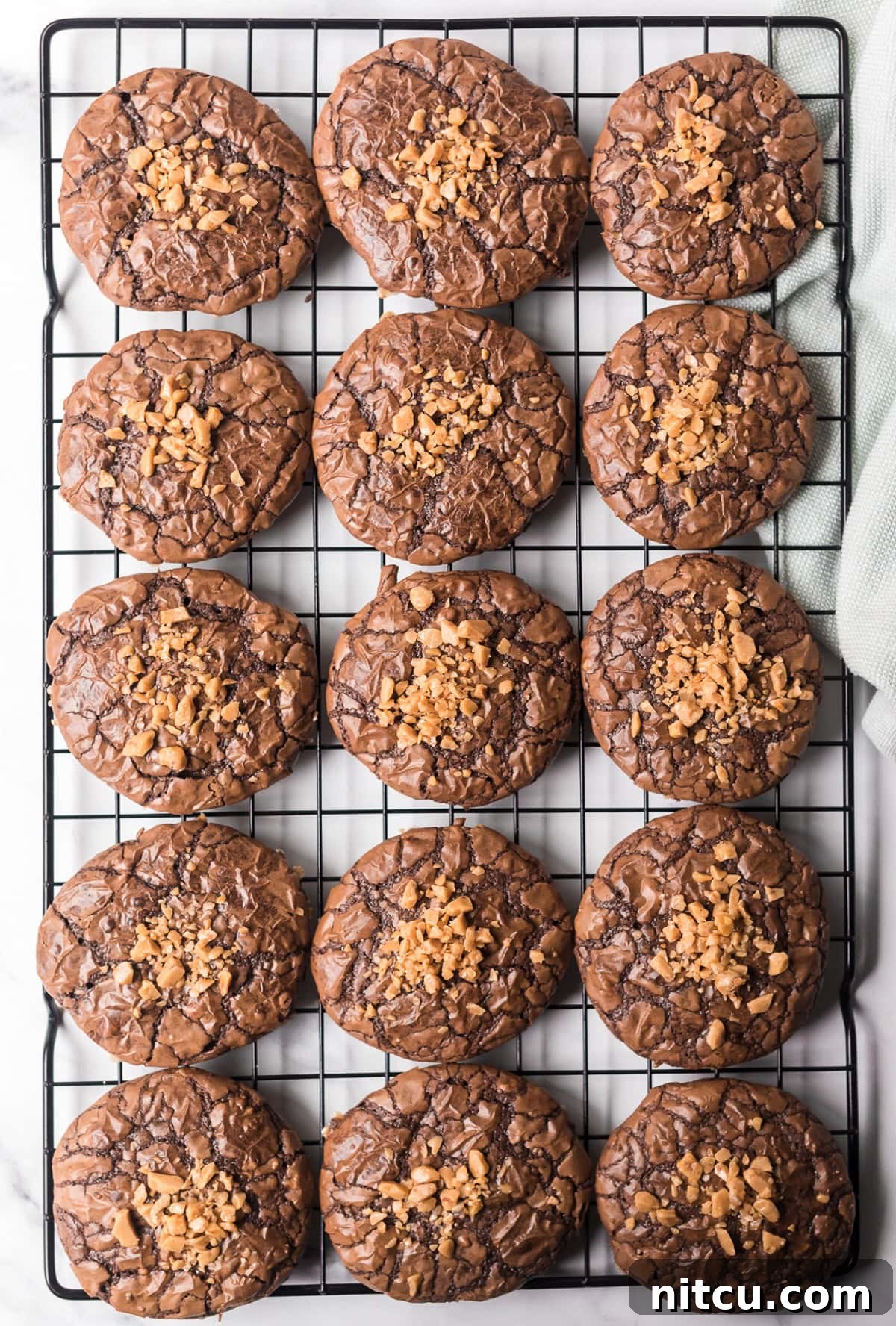 Toffee Fudge Cookies 6 Toffee Brownie Cookies on cooling rack with toffee bits on top