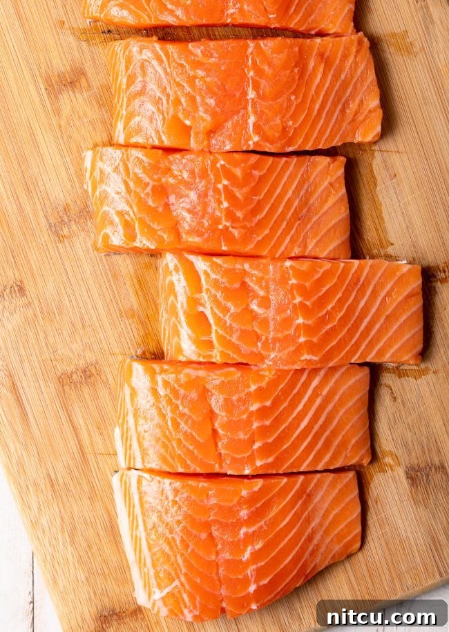 Pineapple Glazed Salmon Delight 6 Salmon fillets on a cutting board.