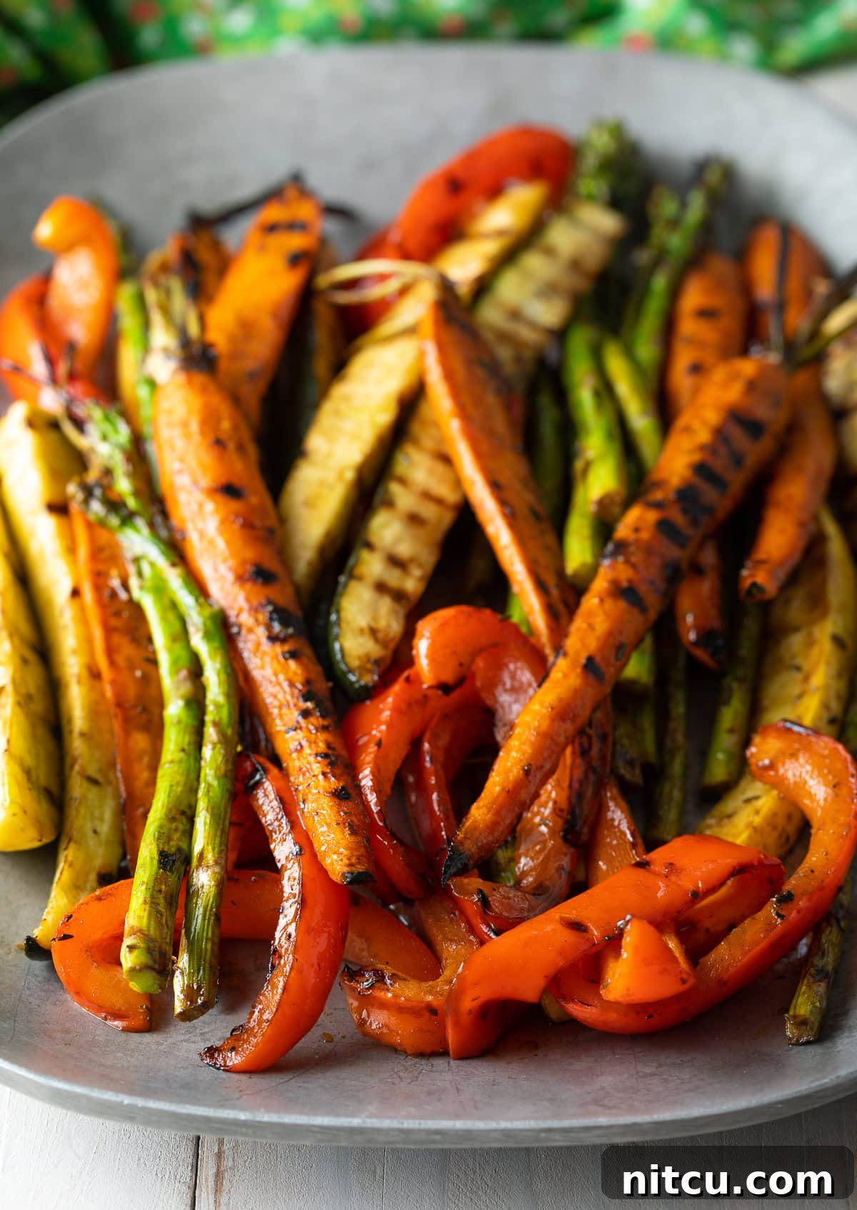 Perfect Grilled Vegetable Marinade 4 Beautifully marinated and grilled carrots, asparagus, bell peppers, and zucchini on a hot grill, showing perfect char marks.