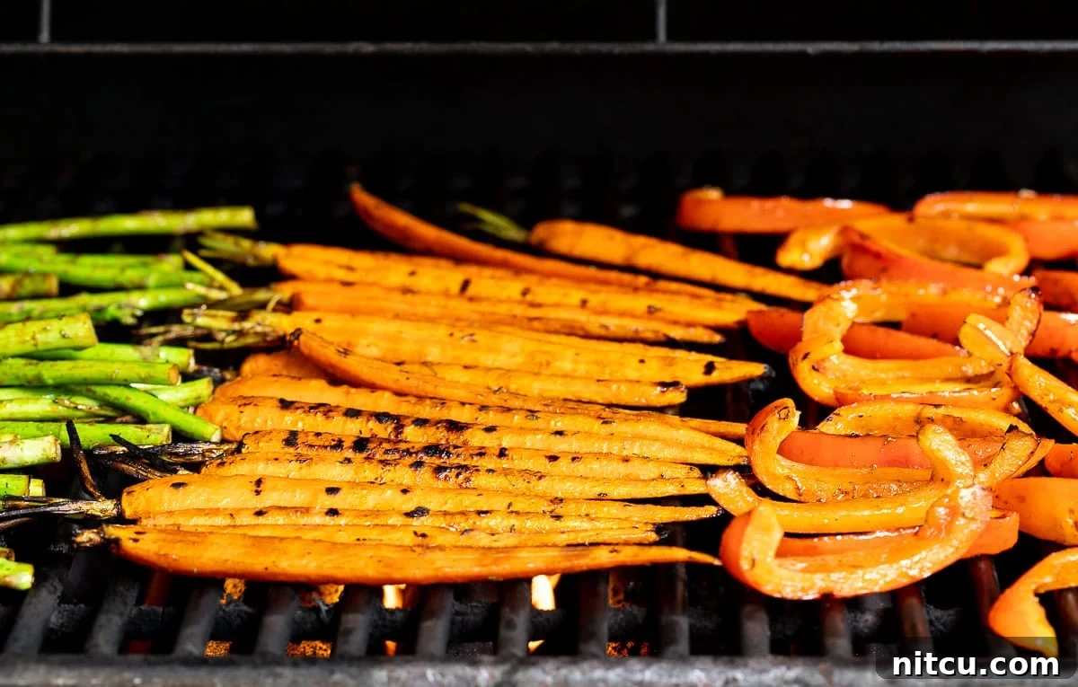 Perfect Grilled Vegetable Marinade 8 Marinated vegetables sizzling on a hot grill, showing smoky char marks and vibrant colors.