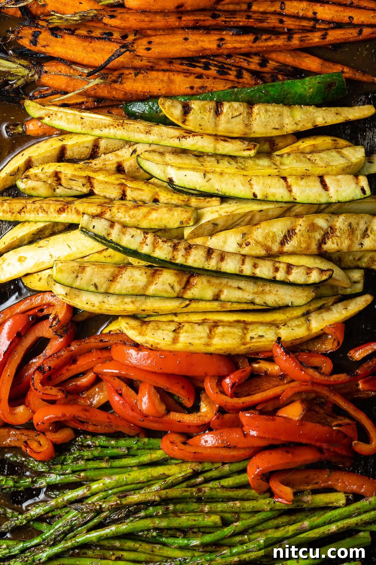 Perfect Grilled Vegetable Marinade 9 Close-up of perfectly grilled summer vegetables on a serving platter, showing vibrant colors and char marks.