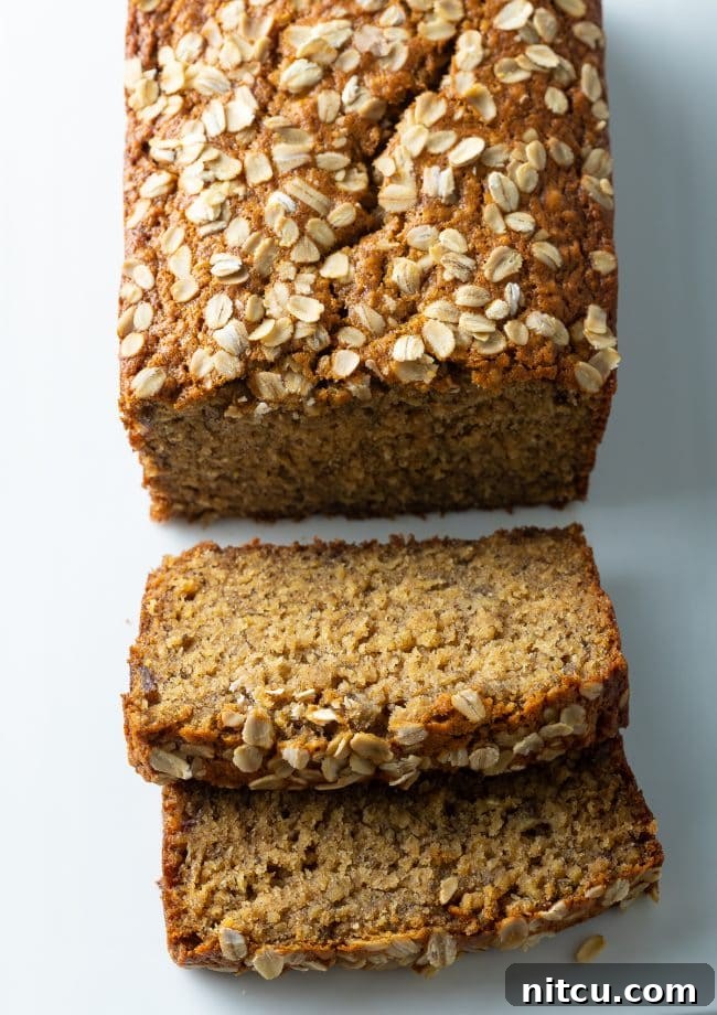 Wholesome Oat & Banana Loaf 4 Freshly baked Oatmeal Banana Bread with two inviting slices removed from the end.