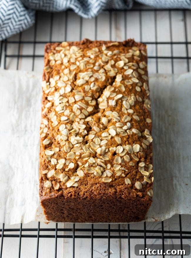 Wholesome Oat & Banana Loaf 5 Freshly baked loaf of banana bread cooling on a wire rack.