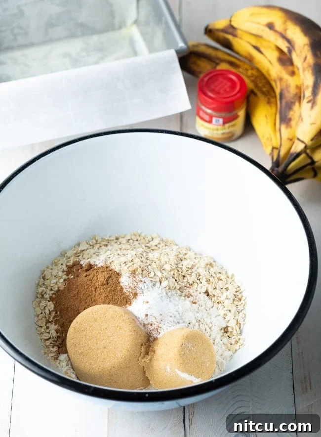 Wholesome Oat & Banana Loaf 6 Dry ingredients for banana bread added into a mixing bowl.