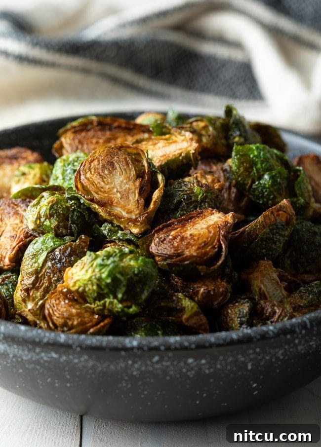 Crispy Golden Brussels Sprouts 5 Closeup of bowl filled with crispy fried Brussels sprouts, ready to be seasoned.