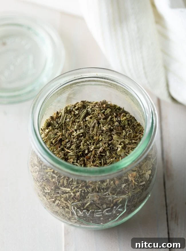 Your Signature Italian Spice Blend 3 Assortment of dried Italian spices and herbs laid out for making homemade seasoning.