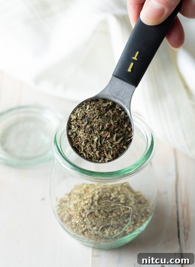 Your Signature Italian Spice Blend 4 Close-up of a variety of dried Italian herbs and spices, showcasing their textures and colors.