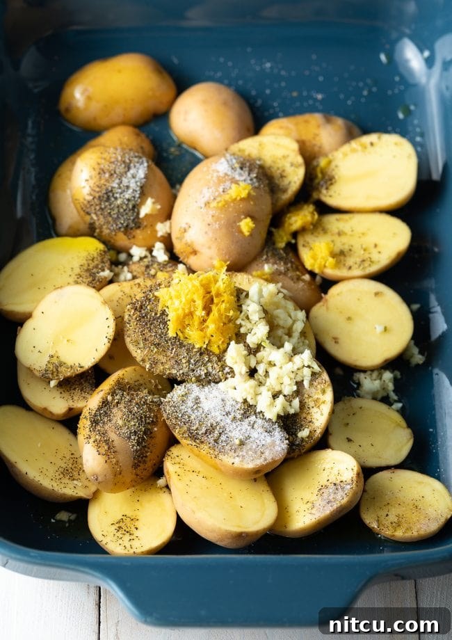 Zesty Greek Lemon Garlic Potatoes 5 Potatoes, garlic, lemon, and oregano in blue baking dish.