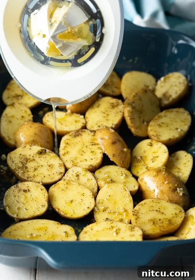Zesty Greek Lemon Garlic Potatoes 6 Lemon and seasonings drizzled over potatoes in casserole dish.