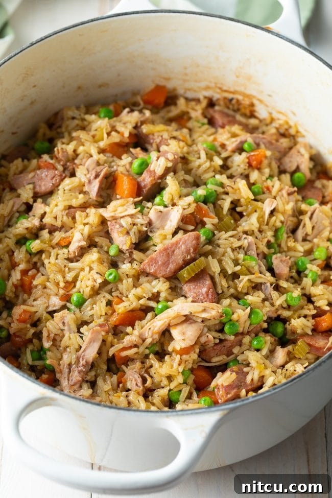 Classic Carolina Chicken Bog 2 Chicken Bog Recipe with sausage and peas in large white pot