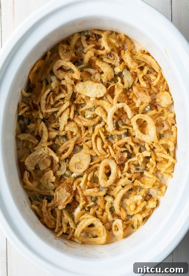 Ultimate Cream Cheese Slow Cooker Green Bean Casserole 7 A large serving dish of the best Green Bean Casserole from scratch, freshly made and topped with an abundance of golden-brown crispy fried onions.