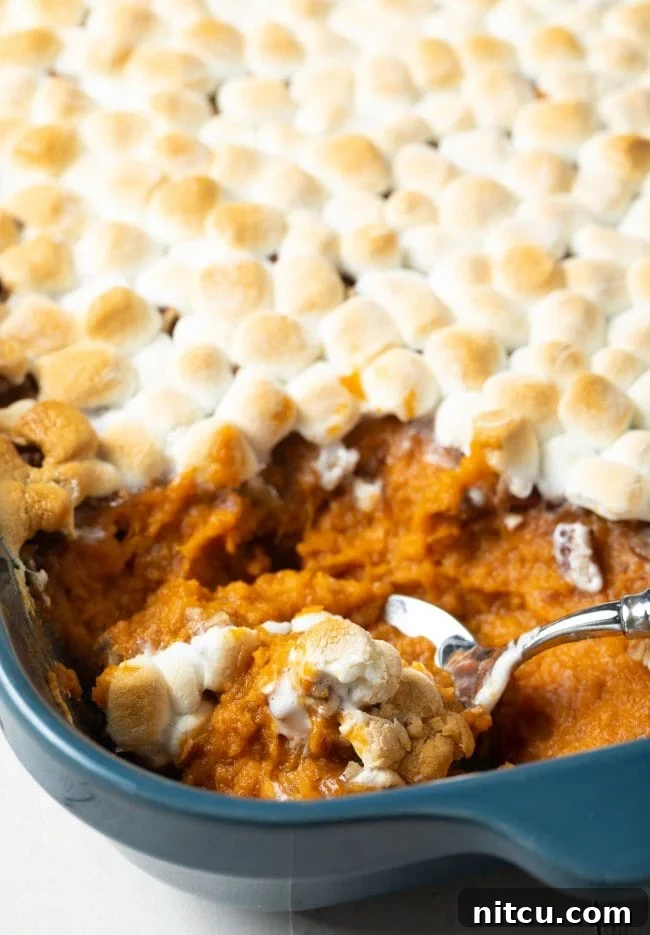 Southern Sunshine Sweet Potato Bake 2 southern sweet potato casserole with marshmallows - spooned out of baking dish