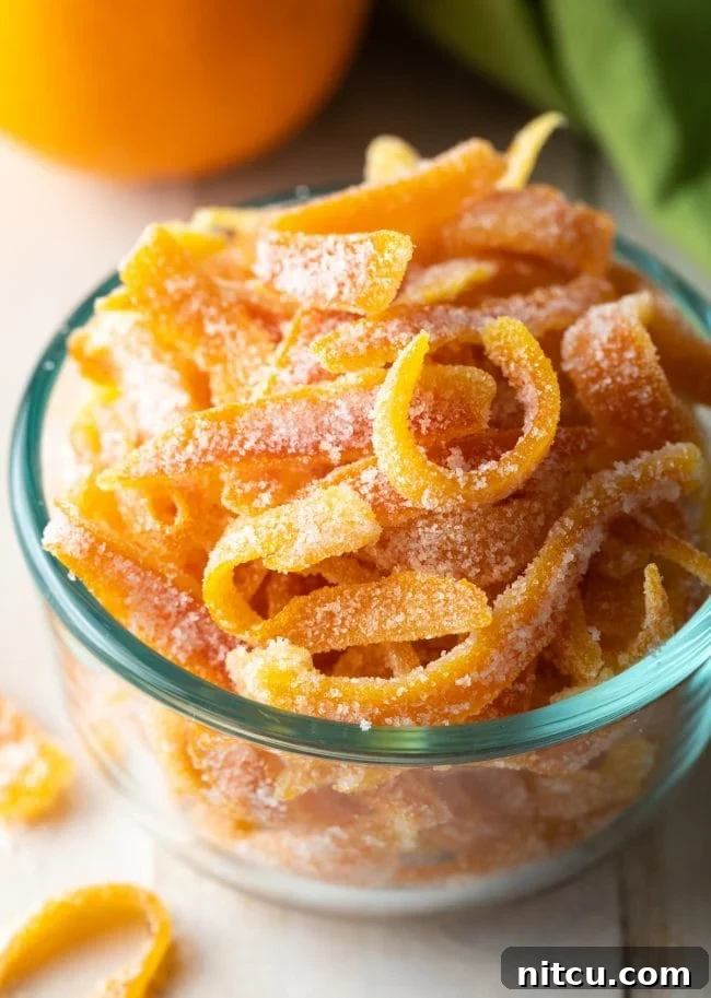 Orange Peel Confections 2 Close up of perfectly crafted candied orange peel in a elegant bowl, showcasing its bright color and sugary coating.