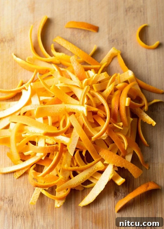 Orange Peel Confections 4 Strips of fresh orange rind, precisely cut and ready for the caramelisation process to become candied orange peel.