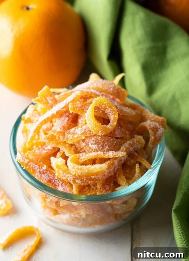 Orange Peel Confections 8 Small glass bowl showcasing the finished easy candied orange peel recipe, ready to be served or gifted.