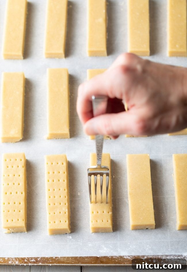 Buttery Scottish Shortbread Delight 7 Hand poking holes in shortbread before it is baked.