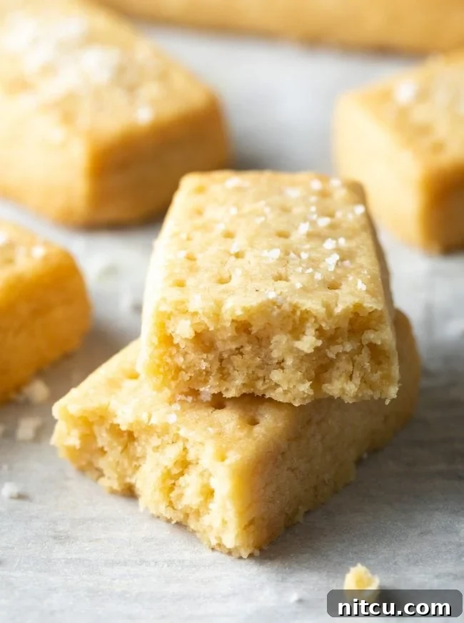 Buttery Scottish Shortbread Delight 10 Shortbread cookie broken in half and stacked on top of each other.