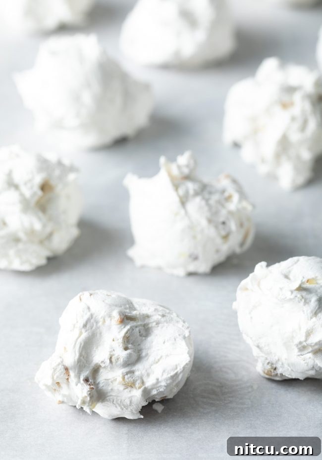 Divine Cloud Candy Delights 7 Close up of meringue dolloped onto a baking sheet.