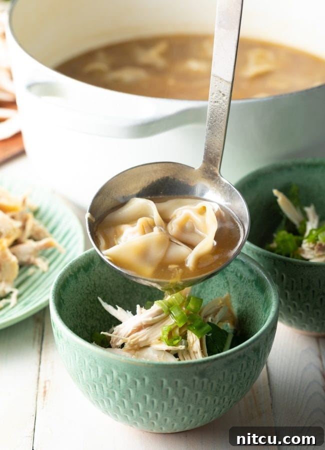 Ultimate Wor Wonton Soup 14 Delicious Wor Wonton Soup being poured over a bowl of fresh vegetables and chicken, ready to be served.