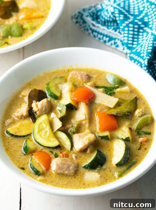 Effortless Instant Pot Thai Green Curry 2 A steaming bowl of vibrant green chicken curry, perfectly plated and ready to enjoy.