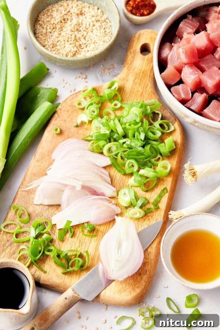 A hand skillfully chopping ingredients for an Ahi Poke Recipe, showing precision in preparation.