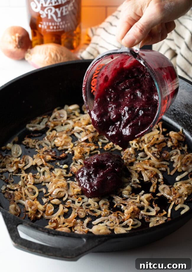 blackberry sauce simmering in a pan